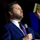 Republican Senate candidate JD Vance holds a piece of paper with the name of former President Donald Trump written on it, as he speaks May 3, 2022, in Cincinnati.